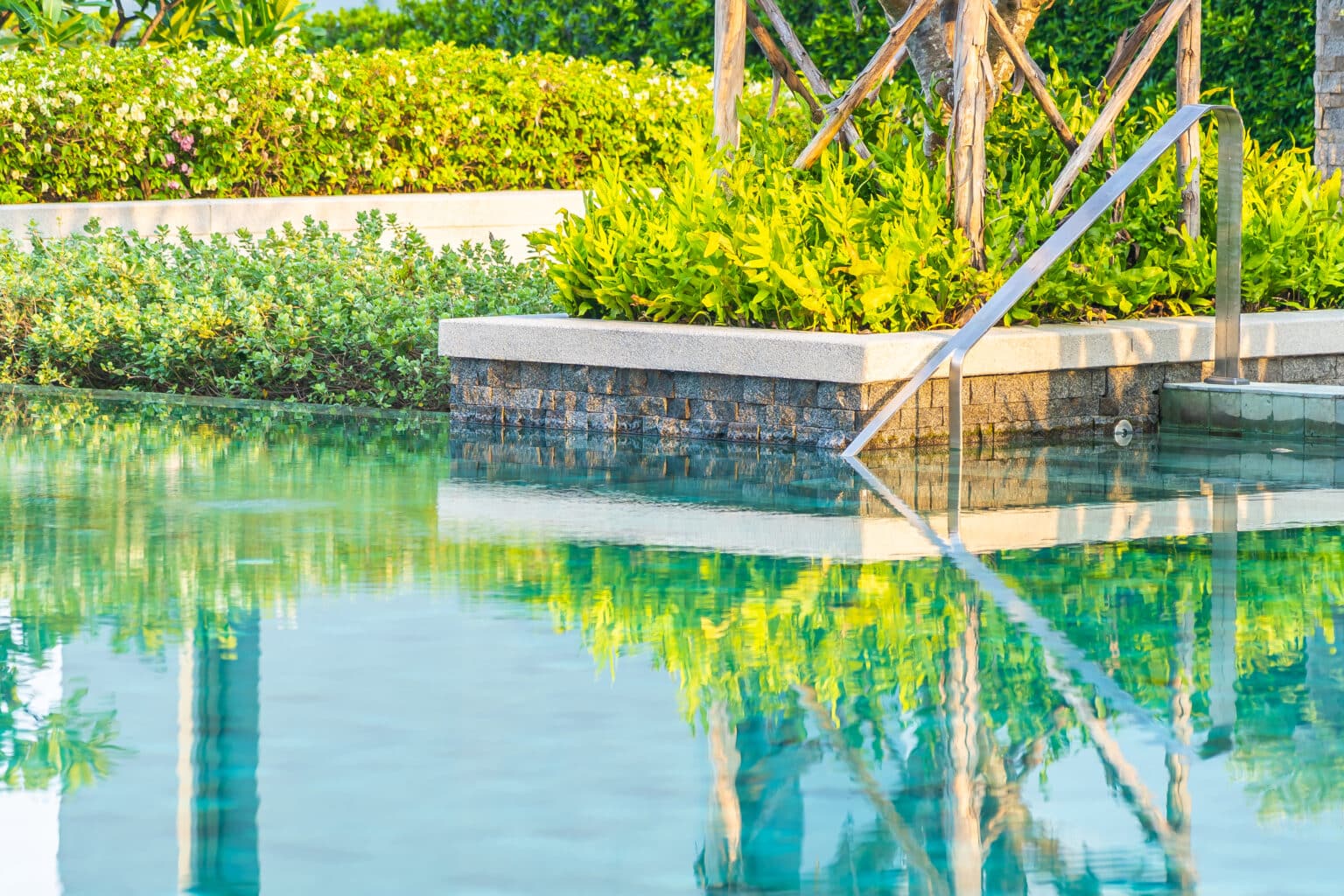 Outdoor swimming pool with umbrella chair lounge around there for leisure travel and vacation concept